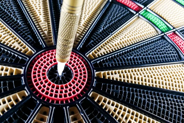 Close-up on dart pin on board bullseye Stock Image