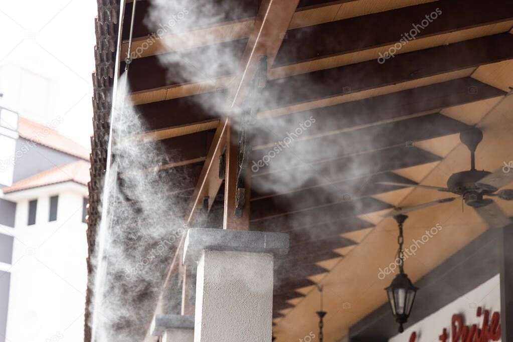 Mist cooling system on commercial building to manage ambient temperature