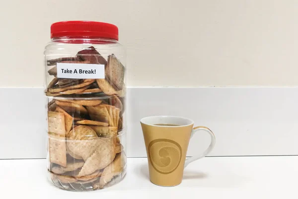 Biscuit in plastic jar with Take A Break word — Stock Photo, Image