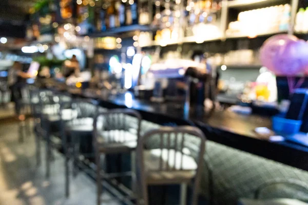 Blurred bar counter in pub with drinks and stools — Stock Photo, Image