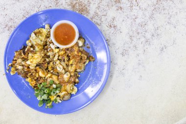 Popular Penang fried oyster omelette egg served with chilli dip