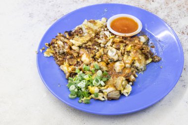 Popular Penang fried oyster omelette egg served with chilli dip