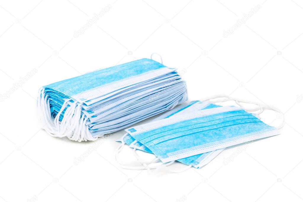 Stack of surgical face mask for protection against germs on white background