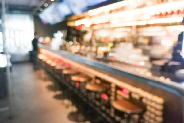 Blurred pub bar counter with stools as background in graphic pursuit