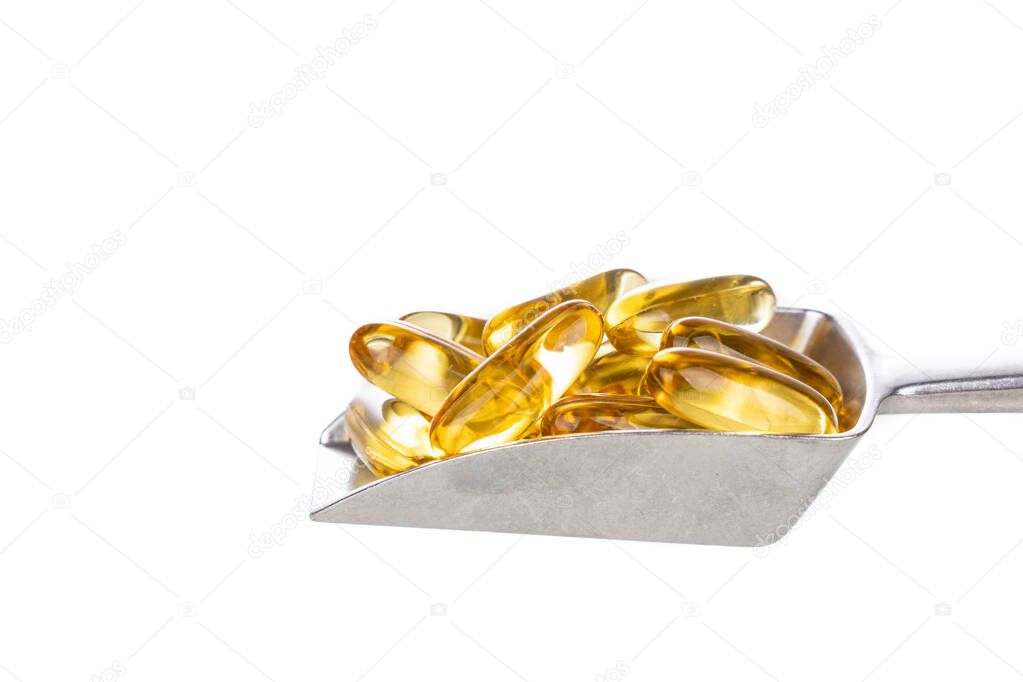 Scoop of fish oil gel capsule containing omega-3 polyunsaturated acid EPA and DHA enhances heart and health on white background