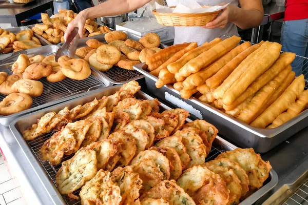 Various types of fried bread sticks or you tiao at hawker stall in Malaysia