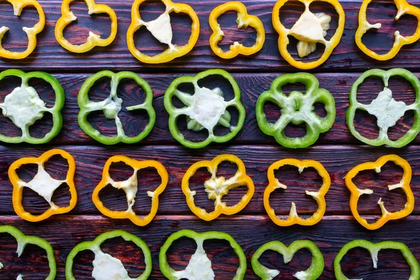 Background of fresh sliced peppers on wooden background — Stock Photo, Image