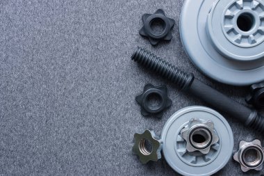 Dumbbell vücut gri bir arka plan üzerinde geliştirme için