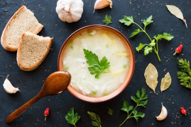 Tavuk çorbası erişte, otlar ve baharatlar siyah bir arka plan ile