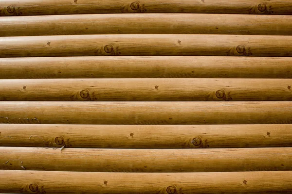 Eine Wand aus Baumstämmen als Hintergrund — Stockfoto