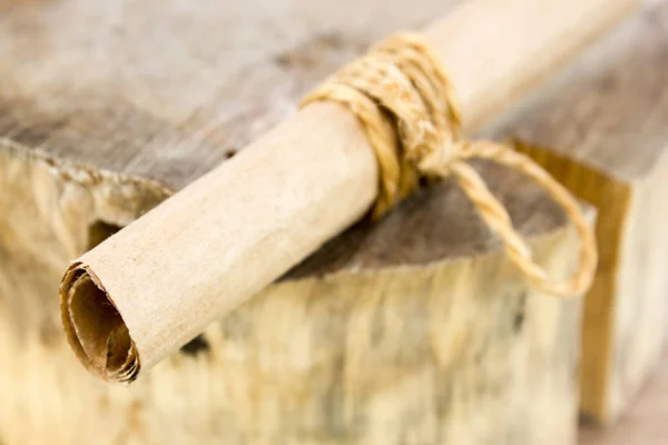 A roll of paper on the piece of wood — Stock Photo, Image
