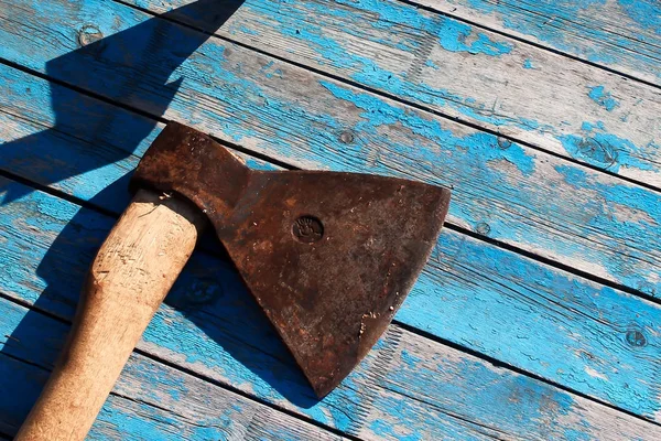 Iron axe on the wooden boards — Stock Photo, Image