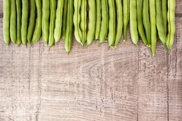 Fresh green beans on wooden