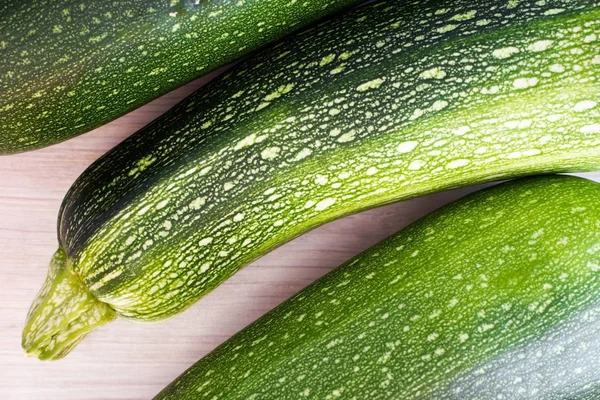 Green zucchini on wooden table — Stock Photo, Image