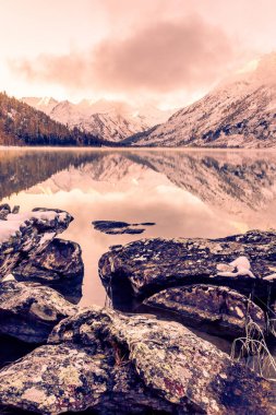 Ayna yüzey dağ gölü. Güzel doğa, Altay Cumhuriyeti Ulusal Park'ta dağlarda bir gezi. Kışın bulutlu hava.