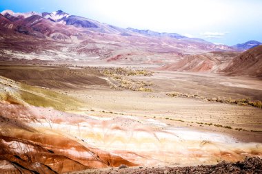 Pembe renkli hills güneşli gökyüzü altında. Kayalar ve pastel renklerle dağlarında.