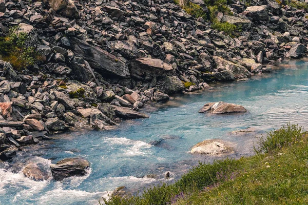 Swift mountain stream. Fast river in mountains among stones