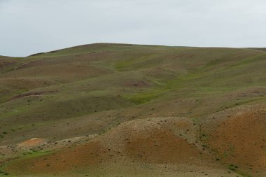 Kibar kırmızı tepeler, dağ vadisinde yolculuk hayvanlar için otlaklar kurak bozkırlarda toprak erozyonu.