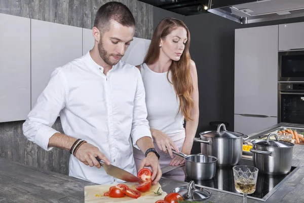 Pareja joven en la cocina moderna prepara sopa de tomate — Foto de Stock