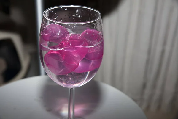 empty glass with ice cubes on white background