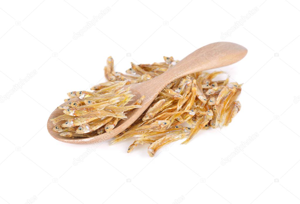 dried tiny salted fish on wooden spoon and on white background