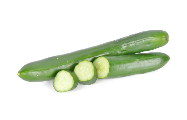 Uncooked whole and sliced fresh Japanese cucumbers on white back — Stock Photo, Image