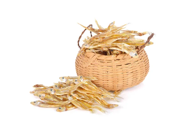 Dried tiny salted fish in bamboo basket and on white background — Stock Photo, Image
