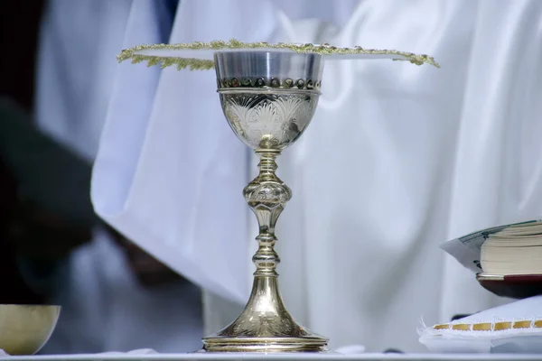 Holy Wafer. Holy communion in church. Taking holy Communion. Priest celebrate mass at the church. Cup of glass with red wine, bread. Feast of Corpus Christi.