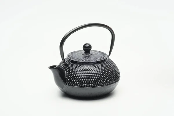 Black cast iron teapot on a white background. — Stock Photo, Image