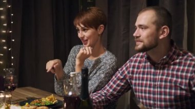 Arkadaşların evde yemek masasında tatil partisi veriyor. Noel 'i kutlayalım. Beş kişi yer, şampanya içer, konuşur ve güler..