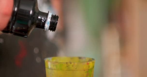 A female artist prepares and kneads paints for drawing. Different bright colors. Close-up of hands. — Stock Video