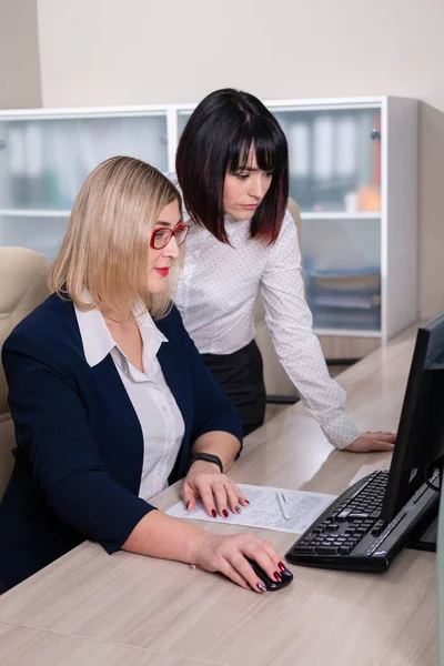 Twee mooie jonge vrouwen werken op kantoor. Copmuter teamwork. — Stockfoto