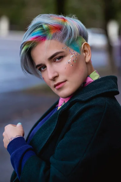 Portrait of a young beautiful woman with a short haircut and dyed hair. Grey main color and yellow, green, blue and red hair color. — Stock Photo, Image