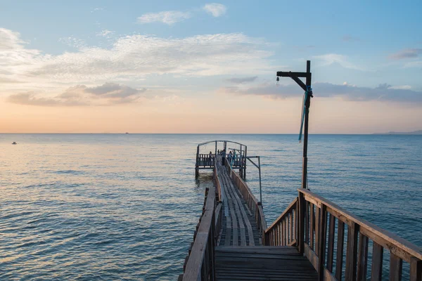 Bridge and pavillion on the sea with people walk on the bridge