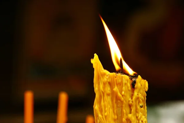 A lighted candle and lit incense. Stock Image