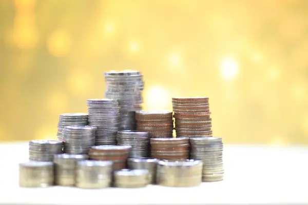 pile of coin stack on golden light background, financial success concept