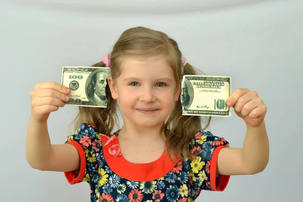 Malá holčička drží v rukou roztržené bankovek, dolar, bankovní krize. — Stock fotografie