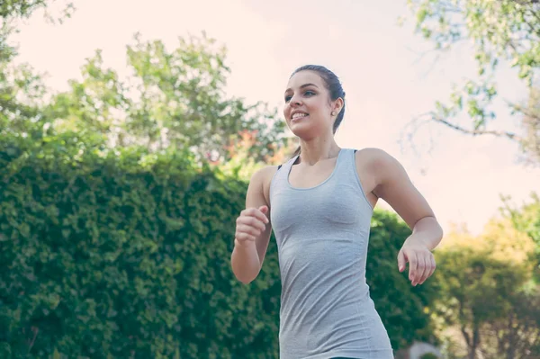 Female running in the road — Stock Photo, Image