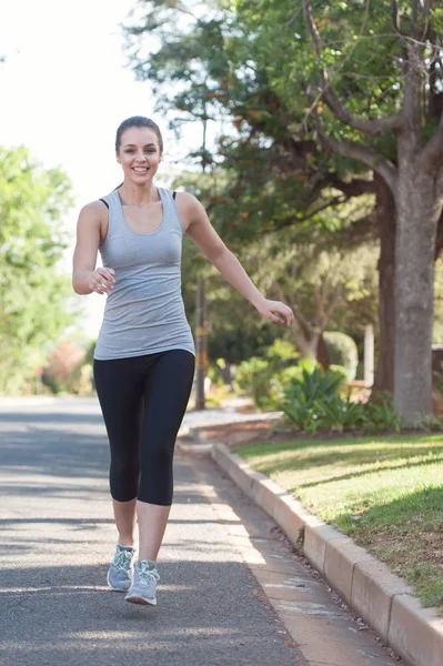 Female running in the road — Stock Photo, Image