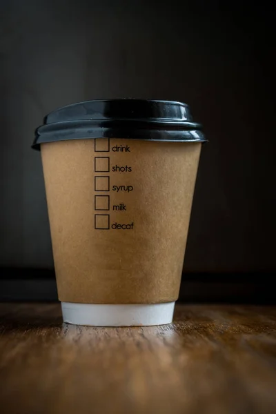 disposable coffee cup on a wooden table