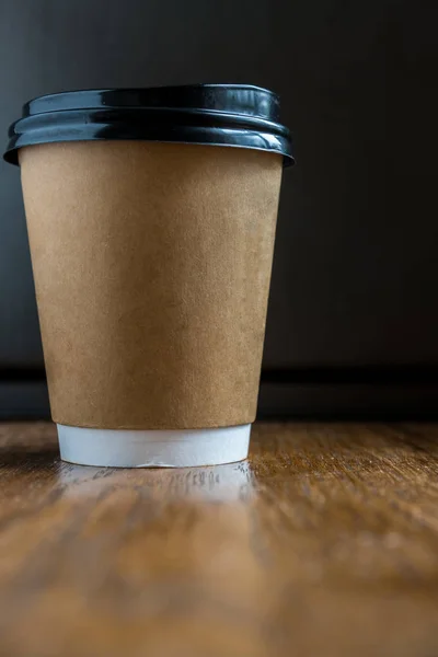disposable coffee cup on a wooden table