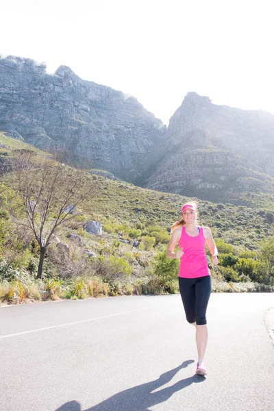 Female runner with mountain background — Stock Photo, Image