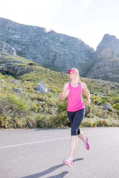 Female runner with mountain background — Stock Photo, Image