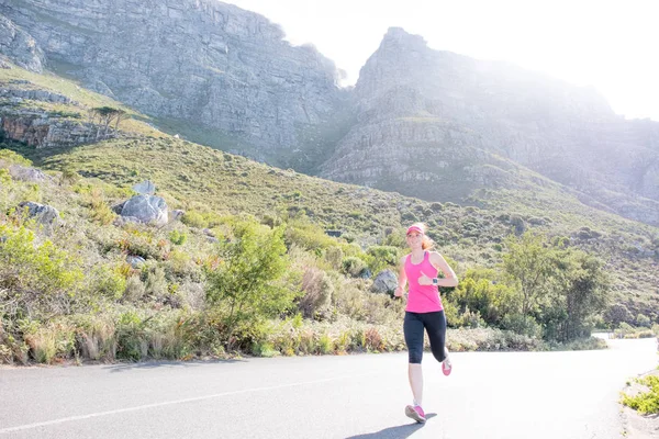 Female runner with mountain background — Stock Photo, Image