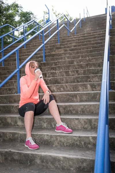 female athlete having a post workout drink