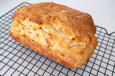 Serinletici bir rafta taze ve altın ev yapımı ekmek.