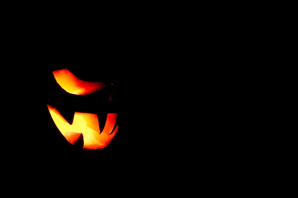 Very scary Halloween pumpkin isolated on black background with i — Stock Photo, Image