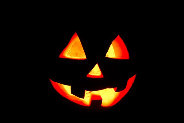 Смешной Хэллоуин тыква изолированы на черном фоне светится от — стоковое фото