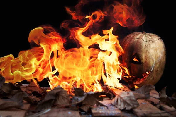 Halloween abóbora vomitando chamas de fogo em um fundo preto — Fotografia de Stock