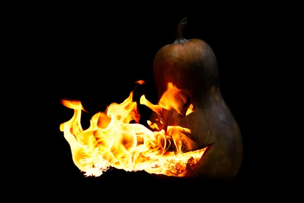 Scary Halloween pumpkin is spewing fire flame isolated on black — Stock Photo, Image